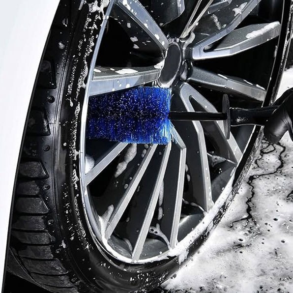 Wheel and rim being hand cleaned with a detail brush